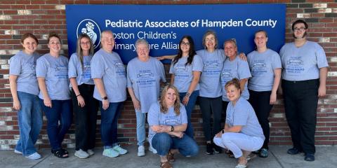 a group of twelve medical professionals in front of a building